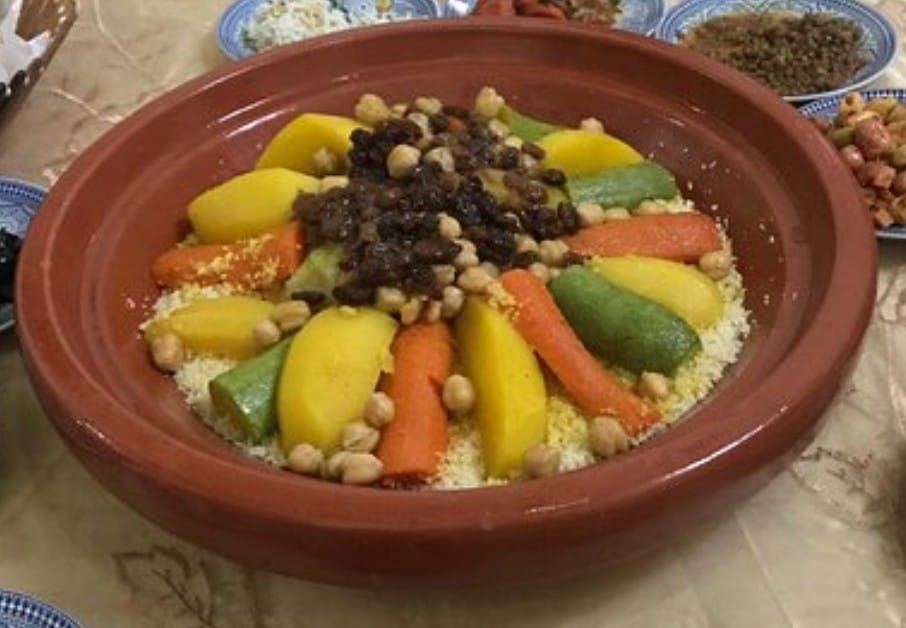 Authentic Moroccan couscous with vegetables in a traditional clay dish